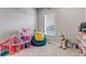 Bright bedroom with play furniture, toys, and a cozy beanbag at 16122 Emporia Way, Brighton, CO 80602