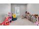 Bright bedroom with play furniture, toys, and a cozy beanbag at 16122 Emporia Way, Brighton, CO 80602