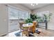 Bright dining area with sliding glass doors leading to the patio, filled with natural light at 16122 Emporia Way, Brighton, CO 80602