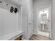 Mudroom with a bench seat and hooks adjacent to a half bathroom with a white pedestal sink at 16122 Emporia Way, Brighton, CO 80602