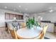 Open-concept kitchen flows into the dining area, featuring granite countertops and wood cabinets at 16122 Emporia Way, Brighton, CO 80602