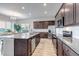Bright kitchen featuring stainless appliances, granite counters, and a large island with seating at 16122 Emporia Way, Brighton, CO 80602