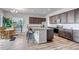 Modern kitchen with stainless steel appliances, granite countertops, and an island with barstool seating at 16122 Emporia Way, Brighton, CO 80602