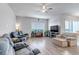 Open-concept living room with hardwood floors, bright window and neutral paint at 16122 Emporia Way, Brighton, CO 80602