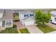 Aerial view of the home showcasing the lawn, driveway, and siding at 9625 Bighorn Way, Littleton, CO 80125