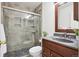 Tiled bathroom featuring a glass shower, dark wood vanity, and modern fixtures at 9625 Bighorn Way, Littleton, CO 80125