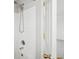 Showerhead and white tile walls within the bathroom shower/tub combo at 9625 Bighorn Way, Littleton, CO 80125