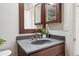 A bathroom vanity with a dark wood cabinet, a grey countertop, and modern fixtures at 9625 Bighorn Way, Littleton, CO 80125