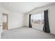 Vaulted bedroom featuring gray carpet, white walls, and a large window with curtains at 9625 Bighorn Way, Littleton, CO 80125