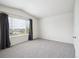Vaulted bedroom featuring gray carpet, white walls, and a large window with curtains at 9625 Bighorn Way, Littleton, CO 80125