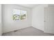 Bright, airy bedroom featuring neutral carpet and a view of the neighborhood at 9625 Bighorn Way, Littleton, CO 80125