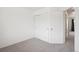 A bright bedroom features neutral carpet and a closet with sliding doors at 9625 Bighorn Way, Littleton, CO 80125