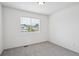 Bright bedroom offers a neutral color palette, plush carpeting, and a window for natural light at 9625 Bighorn Way, Littleton, CO 80125