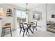 Bright dining area features deck access, modern lighting and decor, and seamless flow into the living room at 9625 Bighorn Way, Littleton, CO 80125