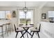 Bright dining area features deck access, modern lighting and decor, and seamless flow into the living room at 9625 Bighorn Way, Littleton, CO 80125