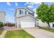 Two-story home with a two-car garage, a manicured lawn, and a mature tree in the front yard at 9625 Bighorn Way, Littleton, CO 80125