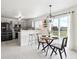 Bright kitchen features stainless steel appliances and eat-in dining space with access to the outdoor deck at 9625 Bighorn Way, Littleton, CO 80125