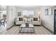 Cozy living room features two comfortable chairs, a stylish coffee table, and a large window at 9625 Bighorn Way, Littleton, CO 80125