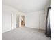 Spacious main bedroom featuring vaulted ceilings, gray carpet, and ensuite bathroom at 9625 Bighorn Way, Littleton, CO 80125
