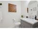 Charming powder room boasts a marble vanity, updated fixtures, modern design, and decorative accents at 9625 Bighorn Way, Littleton, CO 80125
