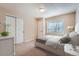 Bright bedroom with neutral walls, carpet, white trim, and a double door closet at 3391 Prairie Vista Dr, Castle Rock, CO 80109