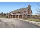 Exterior of a community clubhouse featuring stone pillars and a large chimney at 3391 Prairie Vista Dr, Castle Rock, CO 80109