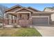 Charming single-Gathering home with a covered front porch and attached garage with concrete driveway at 3391 Prairie Vista Dr, Castle Rock, CO 80109