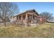 Beautiful home featuring a covered porch with brick pillars and a well-maintained front lawn at 3391 Prairie Vista Dr, Castle Rock, CO 80109