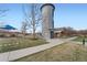 Unique metal tower next to a playground and community clubhouse, surrounded by grass and walkways at 3391 Prairie Vista Dr, Castle Rock, CO 80109