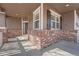 Inviting front porch featuring brick accents and ample natural light at 3391 Prairie Vista Dr, Castle Rock, CO 80109