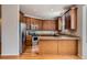 Well-lit kitchen with stainless steel appliances, granite counters, and plenty of cabinet storage at 3391 Prairie Vista Dr, Castle Rock, CO 80109
