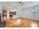 Open-concept living area with hardwood floors, a ceiling fan, and a view of the kitchen at 3391 Prairie Vista Dr, Castle Rock, CO 80109