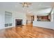 Open-concept living area with hardwood floors, fireplace, and built-in shelving at 3391 Prairie Vista Dr, Castle Rock, CO 80109