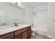 Bathroom with wood vanity, quartz countertop, large mirror and white subway tile shower at 3643 Zuni St, Denver, CO 80211