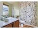 Charming bathroom with floral wallpaper, modern sink, wood vanity, and ample natural light from the window at 3643 Zuni St, Denver, CO 80211