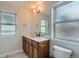 Bathroom with wood vanity, quartz countertop, large mirror and decorative vanity lighting at 3643 Zuni St, Denver, CO 80211