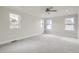 Large bedroom with three bright windows, neutral carpet, ceiling fan, and a light and airy feel at 3643 Zuni St, Denver, CO 80211