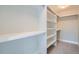 Walk-in closet with built-in shelving and hanging rods, offering ample storage space at 3643 Zuni St, Denver, CO 80211