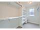 Bright closet featuring built-in shelves, ample storage, and a window for natural light at 3643 Zuni St, Denver, CO 80211