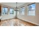 Bright dining room featuring wood floors, chandelier, and multiple windows, creating an inviting atmosphere at 3643 Zuni St, Denver, CO 80211