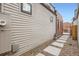 Exterior side shot of house with gravel base and concrete walkway at 3643 Zuni St, Denver, CO 80211