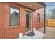 Inviting front entrance featuring brick facade, covered porch and stylish decor elements at 3643 Zuni St, Denver, CO 80211