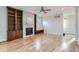 Bright living room featuring built-in shelving, a modern fireplace, and hardwood flooring at 3643 Zuni St, Denver, CO 80211