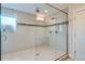 Glass enclosed walk-in shower with grey tile surround and mosaic accent tile at 3643 Zuni St, Denver, CO 80211