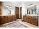 Luxurious main bathroom with dual vanities, wood cabinets, and elegant fixtures at 22759 Mountain Spirit Way, Indian Hills, CO 80454
