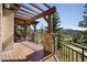 Outdoor patio with a pergola overlooking scenic views and providing ample space for entertaining at 22759 Mountain Spirit Way, Indian Hills, CO 80454