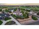 Expansive aerial view of a luxury home showcasing lush landscaping and neighborhood amenities at 8211 E 128Th Pl, Thornton, CO 80602
