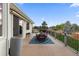 Relaxing back deck with wrought iron table and chairs, and a serene backyard view at 8211 E 128Th Pl, Thornton, CO 80602
