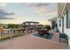 Large back deck with wrought iron furniture, planters, and railing with scenic sunset views at 8211 E 128Th Pl, Thornton, CO 80602