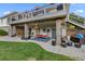 Spacious covered patio with a porch swing, dual ceiling fans, and access to the backyard at 8211 E 128Th Pl, Thornton, CO 80602
